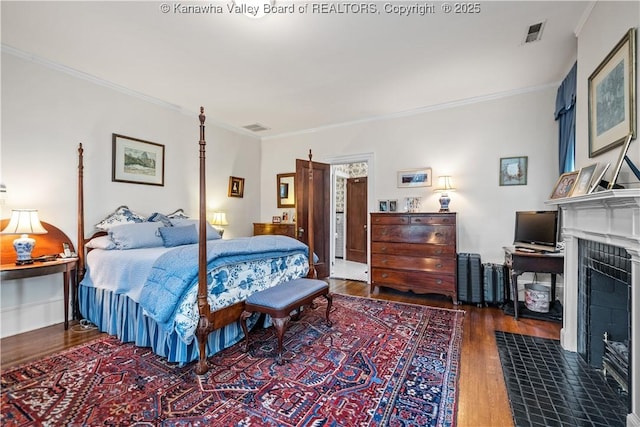 1223 Staunton Rd, Charleston, WV 25314 - bedroom featuring wood finished floors, ornamental molding, and a fireplace with flush hearth