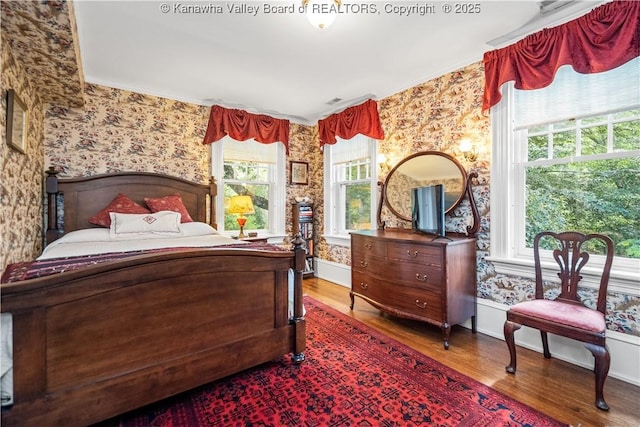 1223 Staunton Rd, Charleston, WV 25314 - bedroom with wallpapered walls, wood finished floors, and baseboards