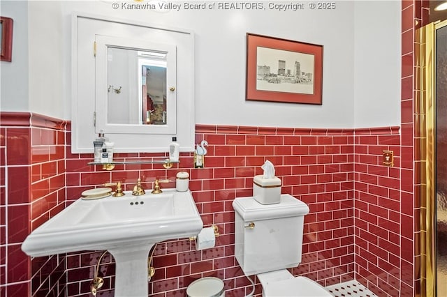 1223 Staunton Rd, Charleston, WV 25314 - bathroom with tile walls, wainscoting, toilet, and a sink