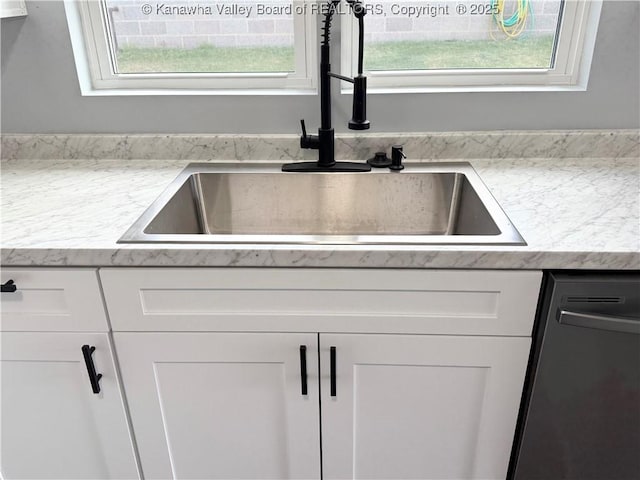 202 Josephine Ave, Madison, WV 25130 - kitchen view of a sink, stainless steel dishwasher, and white cabinetry