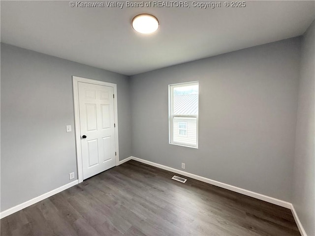 202 Josephine Ave, Madison, WV 25130 - unfurnished bedroom with baseboards and dark wood-style floors