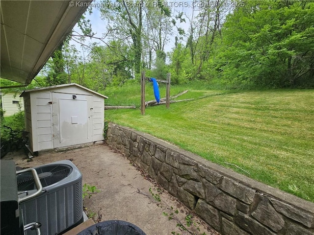 1000 Park Dr, Dunbar, WV 25064 - view of grassy yard featuring central air condition unit, a storage unit, and an outdoor structure