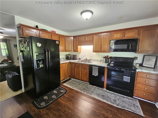 1000 Park Dr, Dunbar, WV 25064 - kitchen with black appliances, a sink, dark wood finished floors, light countertops, and brown cabinetry