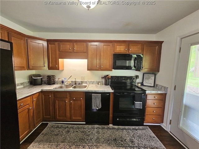 1000 Park Dr, Dunbar, WV 25064 - kitchen with black appliances, a sink, brown cabinets, and dark wood-style flooring