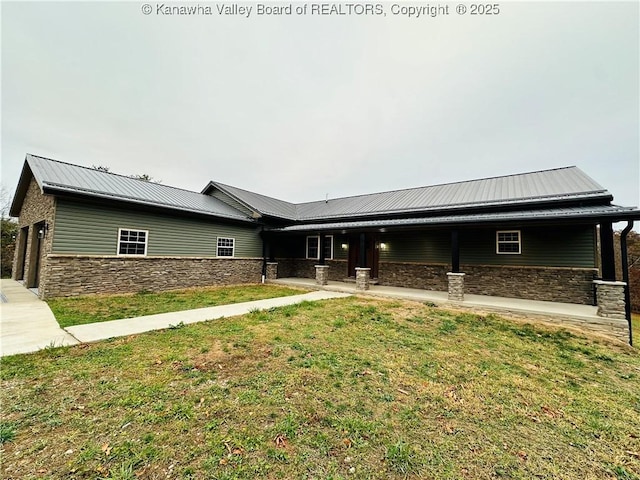 2885 Emma Rd, Given, WV 25245 - view of front facade featuring stone siding, metal roof, and a front lawn