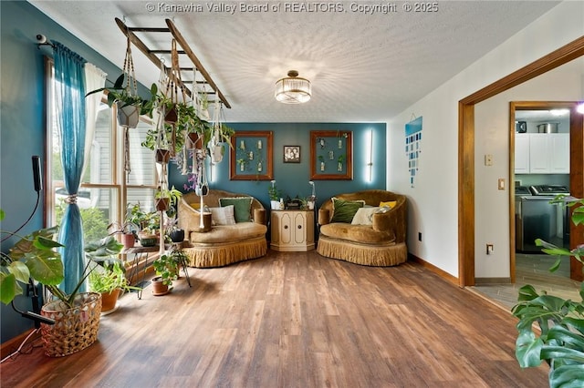 3589 Mount Union Rd, Fraziers Bottom, WV 25082 - sitting room featuring independent washer and dryer, wood finished floors, a textured ceiling, and baseboards