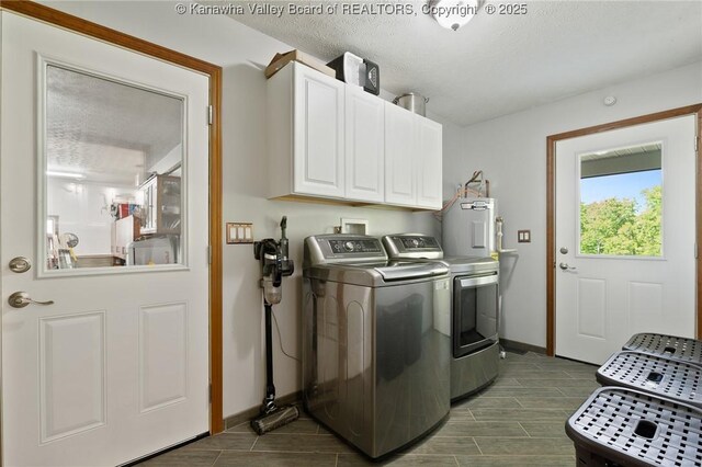 3589 Mount Union Rd, Fraziers Bottom, WV 25082 - washroom featuring washing machine and dryer, water heater, cabinet space, baseboards, and wood tiled floors