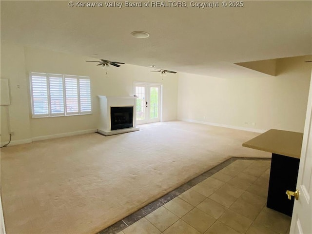 516 Woodbridge Dr, Charleston, WV 25311 - unfurnished living room with light colored carpet, a fireplace with raised hearth, baseboards, ceiling fan, and light tile patterned floors