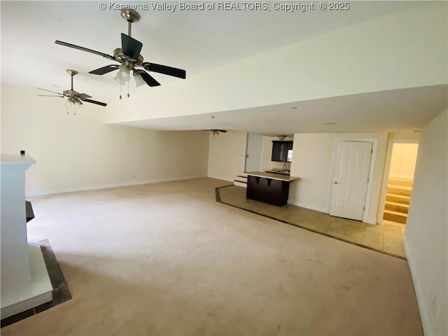 516 Woodbridge Dr, Charleston, WV 25311 - unfurnished living room with light carpet, baseboards, stairway, and ceiling fan
