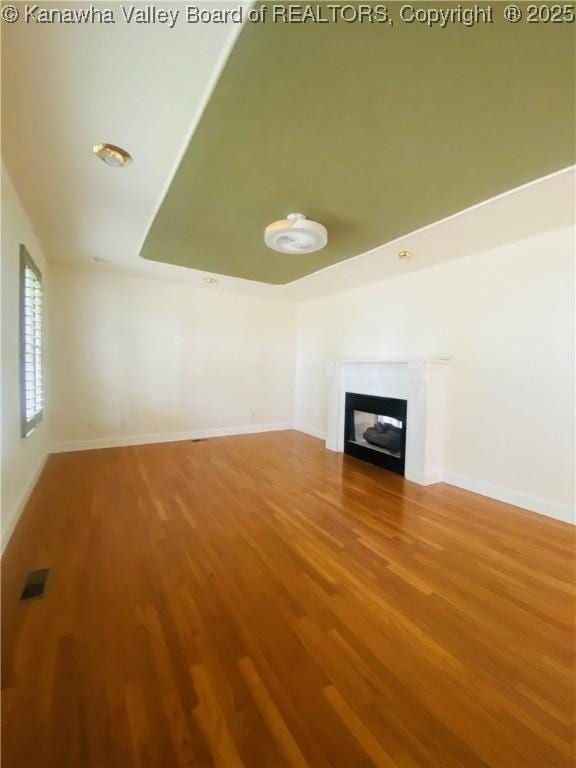 516 Woodbridge Dr, Charleston, WV 25311 - unfurnished living room featuring wood finished floors, a glass covered fireplace, and baseboards
