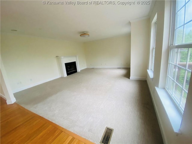 516 Woodbridge Dr, Charleston, WV 25311 - unfurnished living room featuring baseboards, a fireplace, and carpet floors