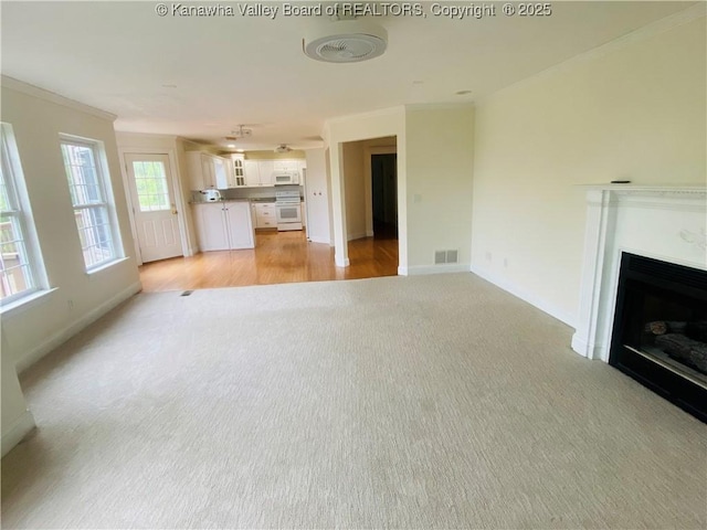 516 Woodbridge Dr, Charleston, WV 25311 - unfurnished living room with light colored carpet, crown molding, a fireplace, and baseboards