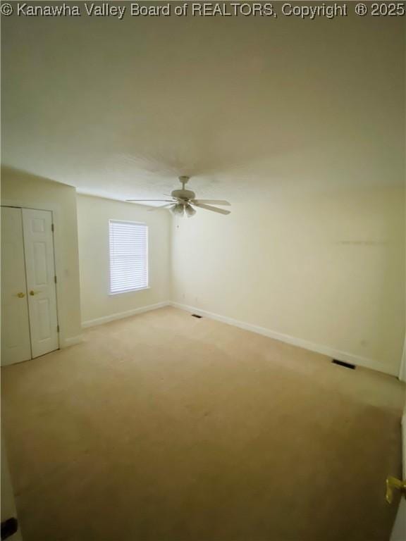516 Woodbridge Dr, Charleston, WV 25311 - spare room with light colored carpet, baseboards, and a ceiling fan