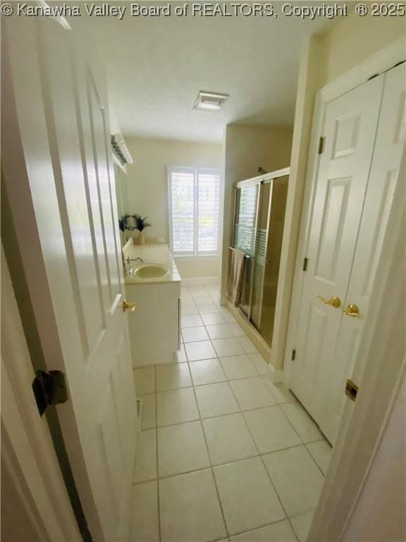 516 Woodbridge Dr, Charleston, WV 25311 - full bath with tile patterned floors, a stall shower, vanity, and baseboards