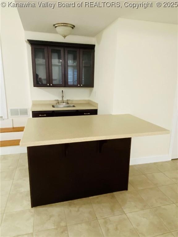 516 Woodbridge Dr, Charleston, WV 25311 - bar with a sink, light tile patterned flooring, and baseboards
