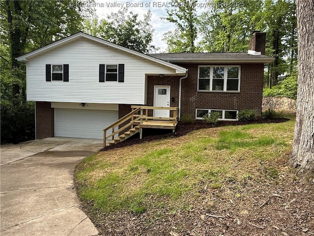 2 Stephanie Ln, Saint Albans, WV 25177 - bi-level home featuring an attached garage, driveway, brick siding, and a chimney