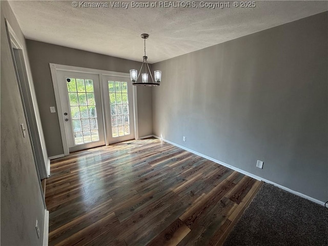 2 Stephanie Ln, Saint Albans, WV 25177 - unfurnished dining area with a chandelier, dark wood finished floors, baseboards, and a textured ceiling