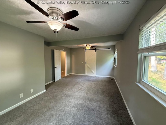2 Stephanie Ln, Saint Albans, WV 25177 - unfurnished bedroom featuring baseboards, a textured ceiling, carpet, ceiling fan, and a barn door