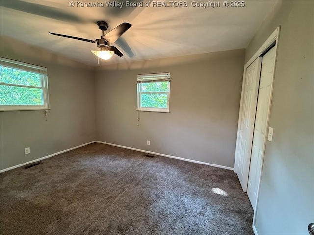 2 Stephanie Ln, Saint Albans, WV 25177 - unfurnished bedroom featuring dark carpet, a closet, baseboards, and ceiling fan