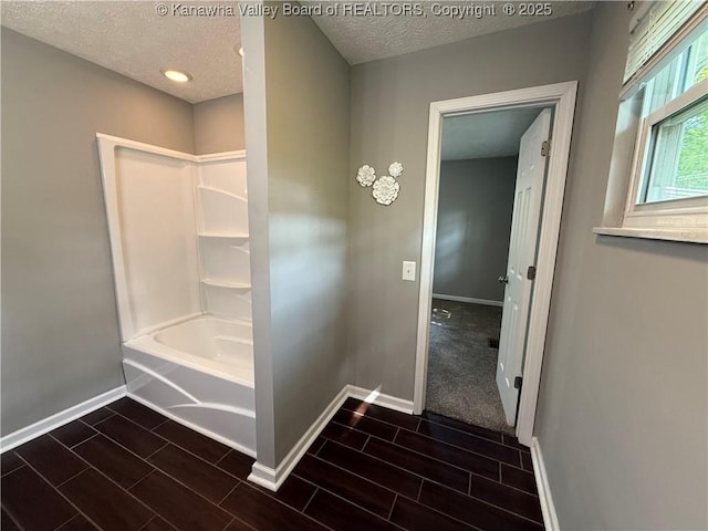 2 Stephanie Ln, Saint Albans, WV 25177 - full bathroom with baseboards, wood finish floors, a textured ceiling, and bathing tub / shower combination