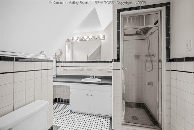 102 49th St SE, Charleston, WV 25304 - bathroom with tile walls, a shower stall, vanity, toilet, and wainscoting