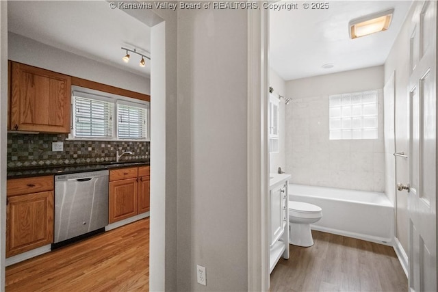 102 49th St SE, Charleston, WV 25304 - full bath featuring vanity, wood finished floors, decorative backsplash, toilet, and shower / bath combination
