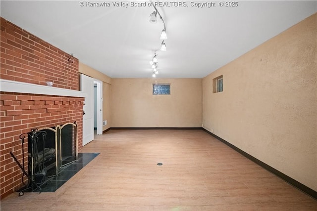 102 49th St SE, Charleston, WV 25304 - unfurnished living room with wood finished floors, a fireplace, and baseboards