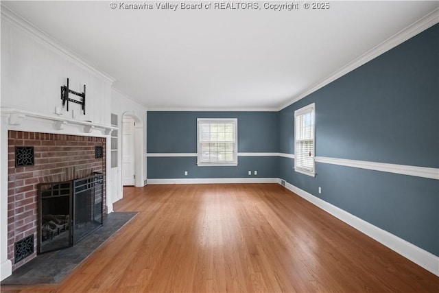 102 49th St SE, Charleston, WV 25304 - unfurnished living room featuring a brick fireplace, baseboards, ornamental molding, and wood finished floors