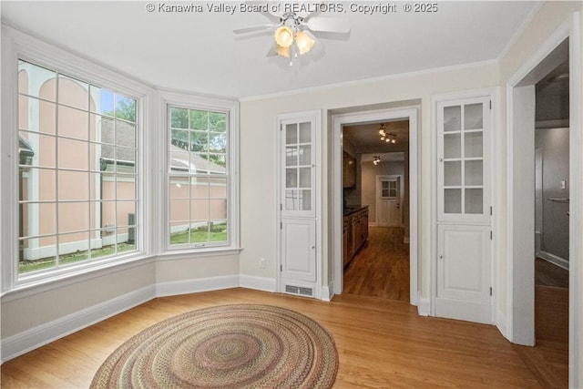 102 49th St SE, Charleston, WV 25304 - spare room with light wood-style floors, a ceiling fan, baseboards, and crown molding