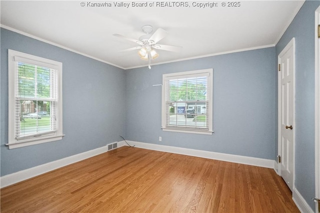 102 49th St SE, Charleston, WV 25304 - empty room with plenty of natural light, ornamental molding, wood finished floors, and baseboards