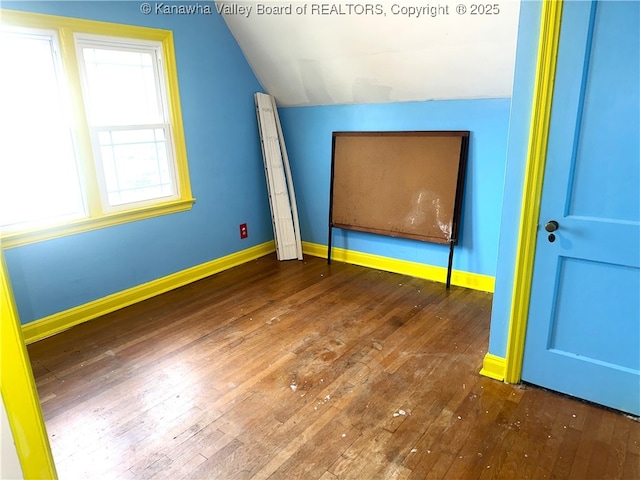 5106 Staunton Ave SE, Charleston, WV 25304 - unfurnished bedroom with vaulted ceiling, wood-type flooring, and baseboards