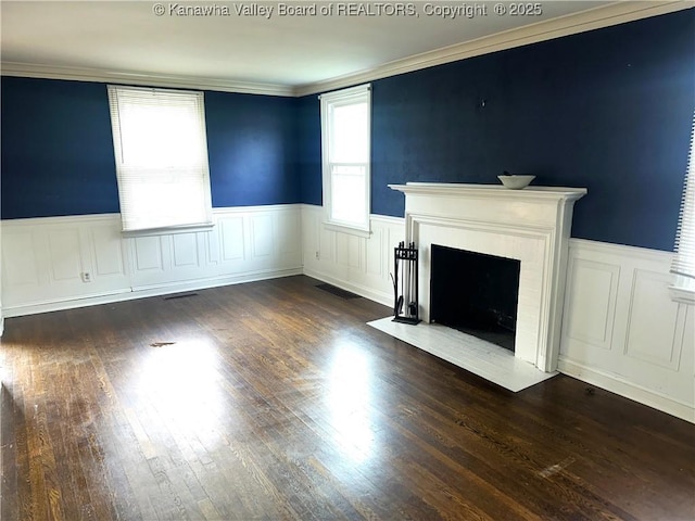 5106 Staunton Ave SE, Charleston, WV 25304 - unfurnished living room featuring a wainscoted wall, a fireplace with flush hearth, dark wood finished floors, ornamental molding, and a decorative wall