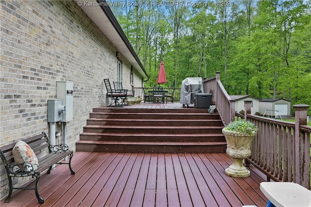 3282 Greenview Rd, South Charleston, WV 25303 - wooden deck with outdoor dining area, an outdoor structure, and central AC unit