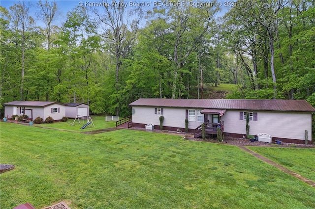 3282 Greenview Rd, South Charleston, WV 25303 - view of front of house with a front yard, metal roof, and a wooded view