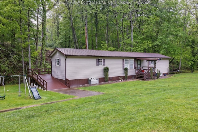3282 Greenview Rd, South Charleston, WV 25303 - view of front facade featuring a front lawn, metal roof, a wooded view, and crawl space