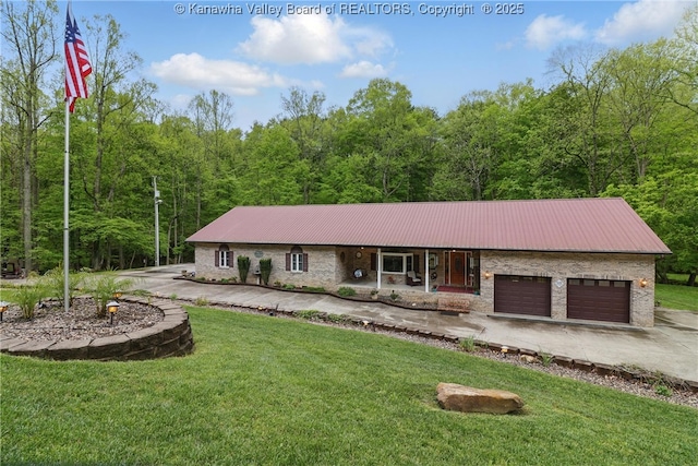 3282 Greenview Rd, South Charleston, WV 25303 - view of front of house with a front yard, a garage, driveway, and metal roof