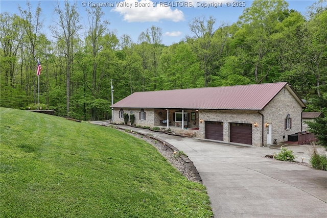 3282 Greenview Rd, South Charleston, WV 25303 - view of front of house with a front yard, an attached garage, metal roof, driveway, and a view of trees