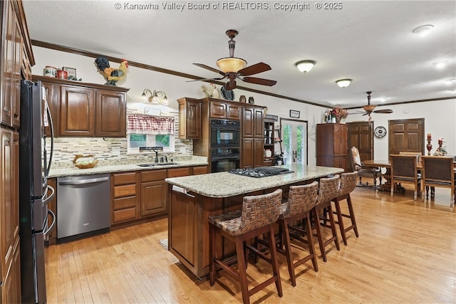 3282 Greenview Rd, South Charleston, WV 25303 - kitchen with black appliances, a ceiling fan, a sink, light wood-style flooring, and ornamental molding