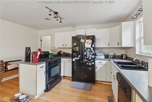 3282 Greenview Rd, South Charleston, WV 25303 - kitchen with black appliances, a sink, a peninsula, and light wood-style floors