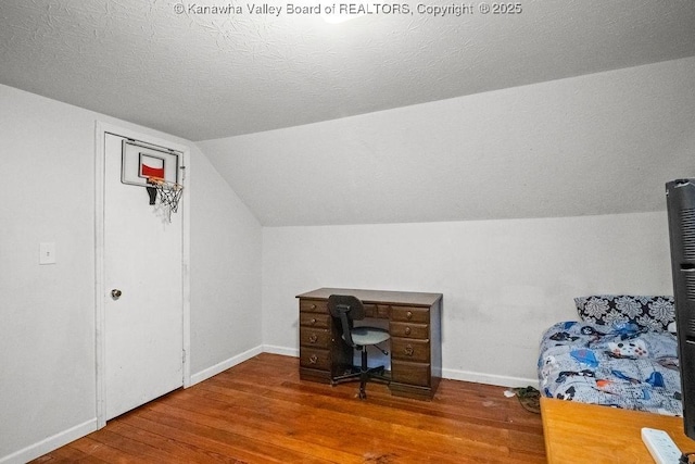 home office with wood finished floors, lofted ceiling, and baseboards