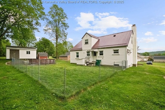 back of property with a chimney and metal roof
