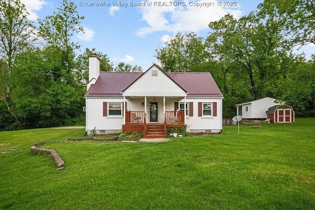 view of front of property featuring covered porch, a storage shed, crawl space, a front yard, and an outdoor structure