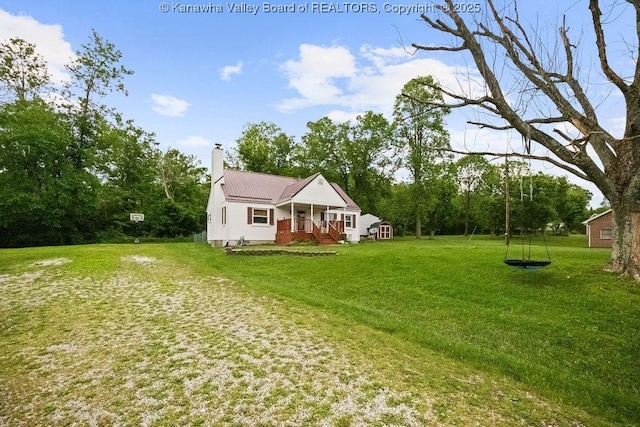 view of green lawn with a porch
