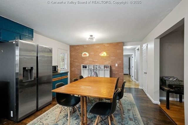 dining area featuring dark wood-style flooring