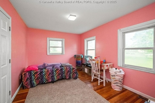 bedroom featuring wood finished floors and baseboards