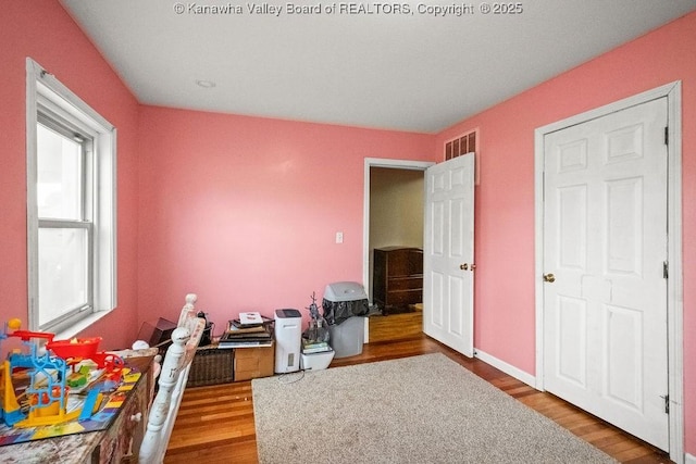 bedroom featuring wood finished floors and baseboards