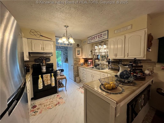 103 Chestnut Dr, Peytona, WV 25154 - kitchen with freestanding refrigerator, black / electric stove, white cabinets, and a textured ceiling