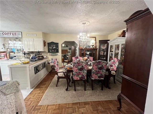 103 Chestnut Dr, Peytona, WV 25154 - dining area with a chandelier and a textured ceiling