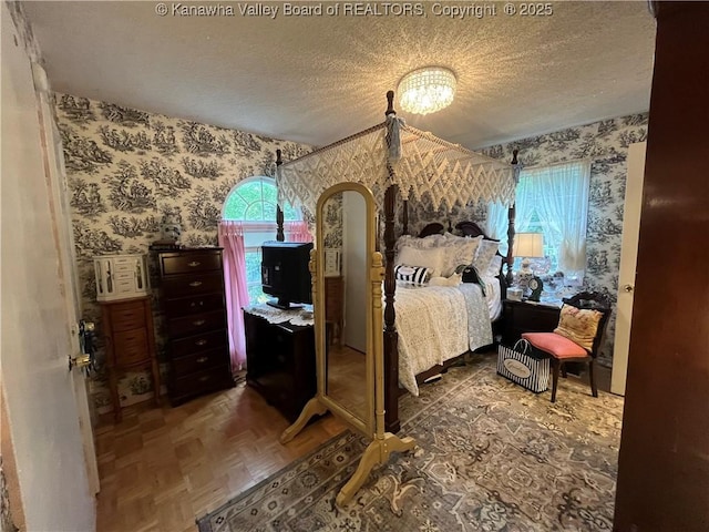103 Chestnut Dr, Peytona, WV 25154 - bedroom featuring wallpapered walls, a textured ceiling, multiple windows, and arched walkways