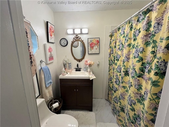 103 Chestnut Dr, Peytona, WV 25154 - bathroom with marble look tile flooring, toilet, a textured ceiling, vanity, and a shower with curtain